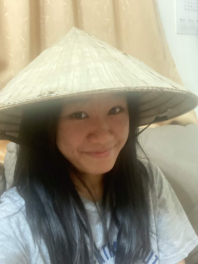 Jamily smiling in a conical hat